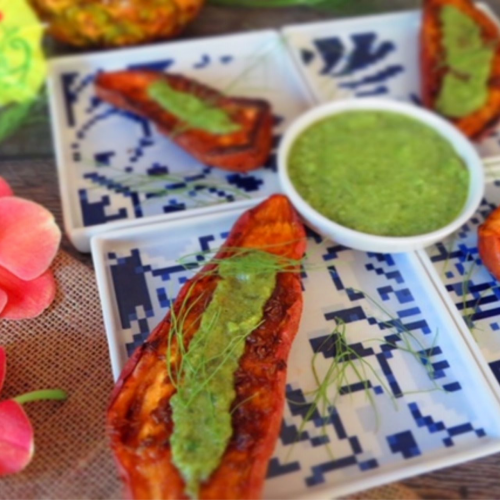 Slices of grilled sweet potatoes with mint tahini sauce drizzled on top