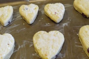 Orange scones cut into shapes and placed on a tray